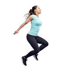 Image showing happy smiling sporty young woman jumping in air