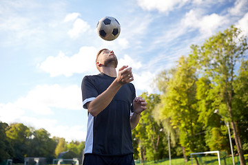 Image showing soccer player playing with ball on field