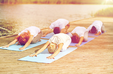 Image showing group of people making yoga exercises outdoors