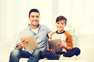 Image showing happy father and son with tablet pc at home