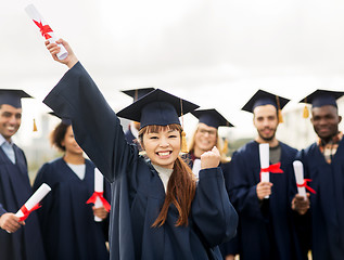 Image showing happy student with diploma celebrating graduation