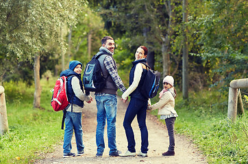 Image showing happy family with backpacks hiking walking