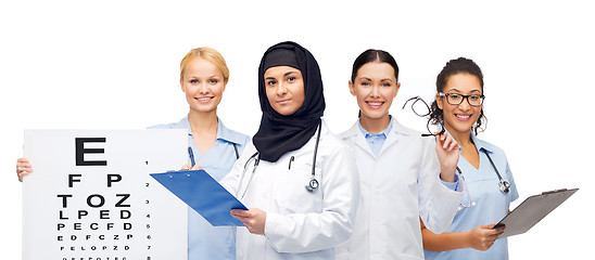 Image showing doctors with clipboards, eye chart and glasses