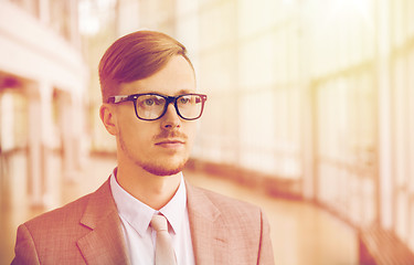 Image showing young businessman in suit and glasses at office