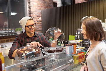 Image showing man or barman with cakes serving customer at cafe