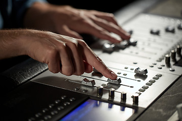 Image showing hands on mixing console in music recording studio