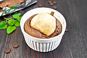 Image showing Cake chocolate with pear in white bowl on dark board