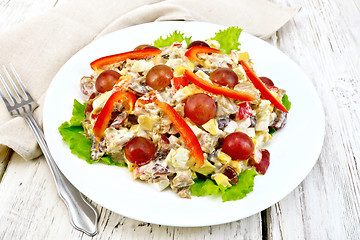 Image showing Salad of meat and cheese with grapes on light board