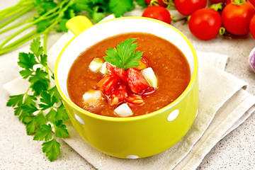 Image showing Soup tomato in yellow bowl on napkin