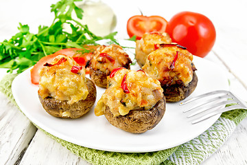 Image showing Champignons stuffed with meat and peppers in plate on napkin