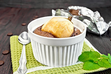 Image showing Cake chocolate with pear in white bowl on green napkin