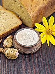 Image showing Flour of Jerusalem artichoke in clay bowl with bread on board