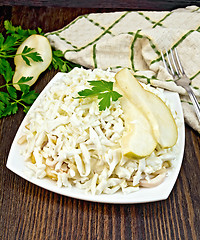 Image showing Salad of squid and pears on dark board