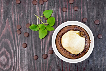 Image showing Cake with chocolate and pear in white bowl on board top