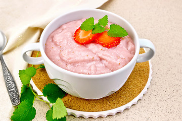 Image showing Soup strawberry in bowl on stone table