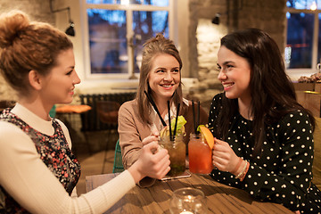 Image showing happy friends clinking drinks at restaurant