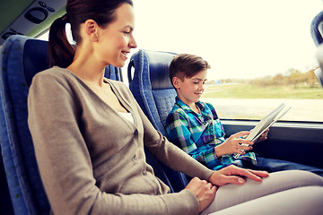 Image showing happy family with tablet pc sitting in travel bus