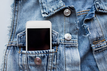 Image showing smartphone in pocket of denim jacket or waistcoat