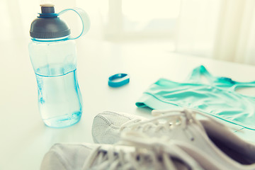 Image showing close up of sportswear, bracelet and bottle