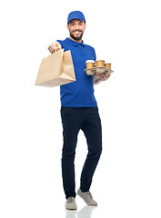Image showing happy delivery man with coffee and food in bag