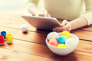 Image showing close up of woman with tablet pc and easter eggs