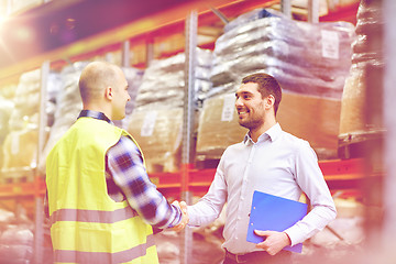 Image showing worker and businessmen with clipboard at warehouse