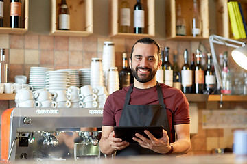 Image showing man, barman or waiter with tablet pc at bar 