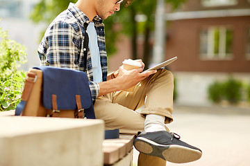 Image showing man with tablet pc and coffee on city street bench