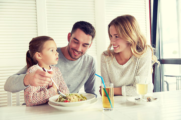 Image showing happy family having dinner at restaurant or cafe