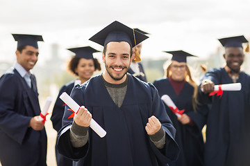 Image showing happy student with diploma celebrating graduation