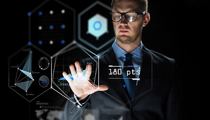 Image showing businessman touching virtual screen projection