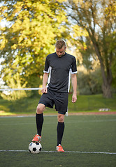 Image showing soccer player playing with ball on football field