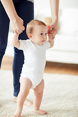 Image showing happy baby learning to walk with mother help