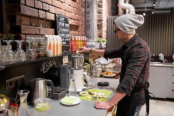 Image showing man or barman cooking smoothie at vegan cafe