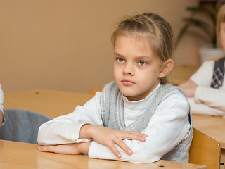 Image showing Diligent student in the classroom listening to a teacher at school