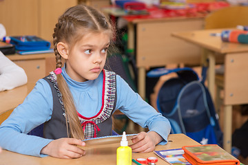 Image showing Girl in school to the labor class has not understood the task and with a puzzled looking at teacher