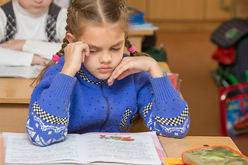 Image showing First grader girl feels bad in the classroom at school