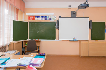 Image showing A view of the teacher\'s desk and blackboard in elementary school classroom