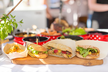 Image showing Varieties of home made sandwiches beeing sold on street stall.