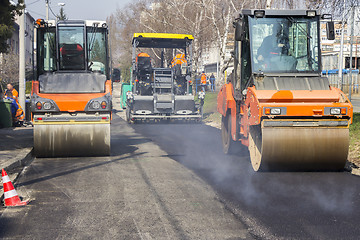 Image showing Road roller compacting asphalt 