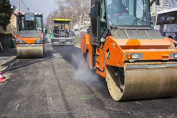 Image showing Road roller compacting asphalt 