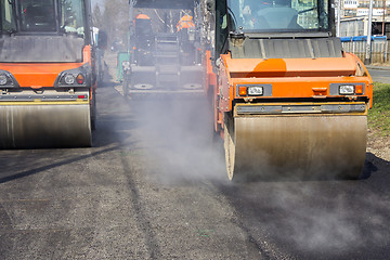 Image showing Road roller compacting asphalt 