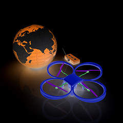 Image showing Quadrocopter Drone with Earth Globe and remote controller on a w