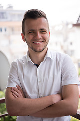 Image showing man standing at balcony