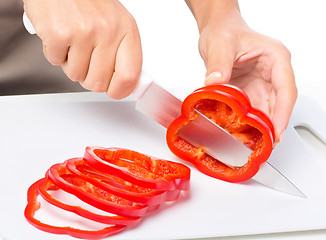 Image showing Cook is chopping bell pepper