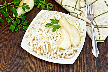 Image showing Salad of squid and pears with towel on board