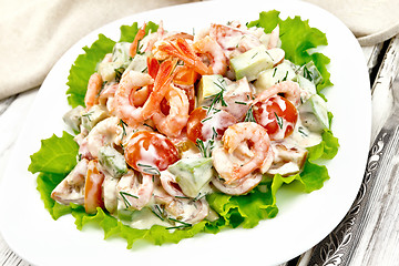 Image showing Salad with shrimp and avocado in plate on board