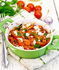 Image showing Shrimp and tomato with feta in pan on light board