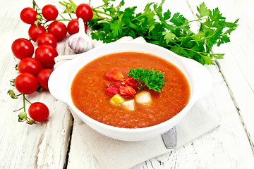 Image showing Soup tomato in white bowl with vegetables on napkin