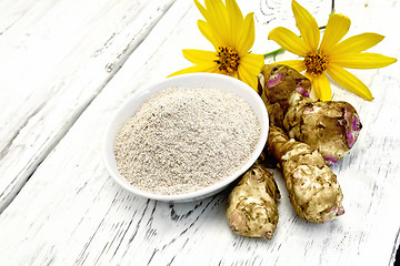 Image showing Flour of Jerusalem artichoke in bowl with vegetables on light  b